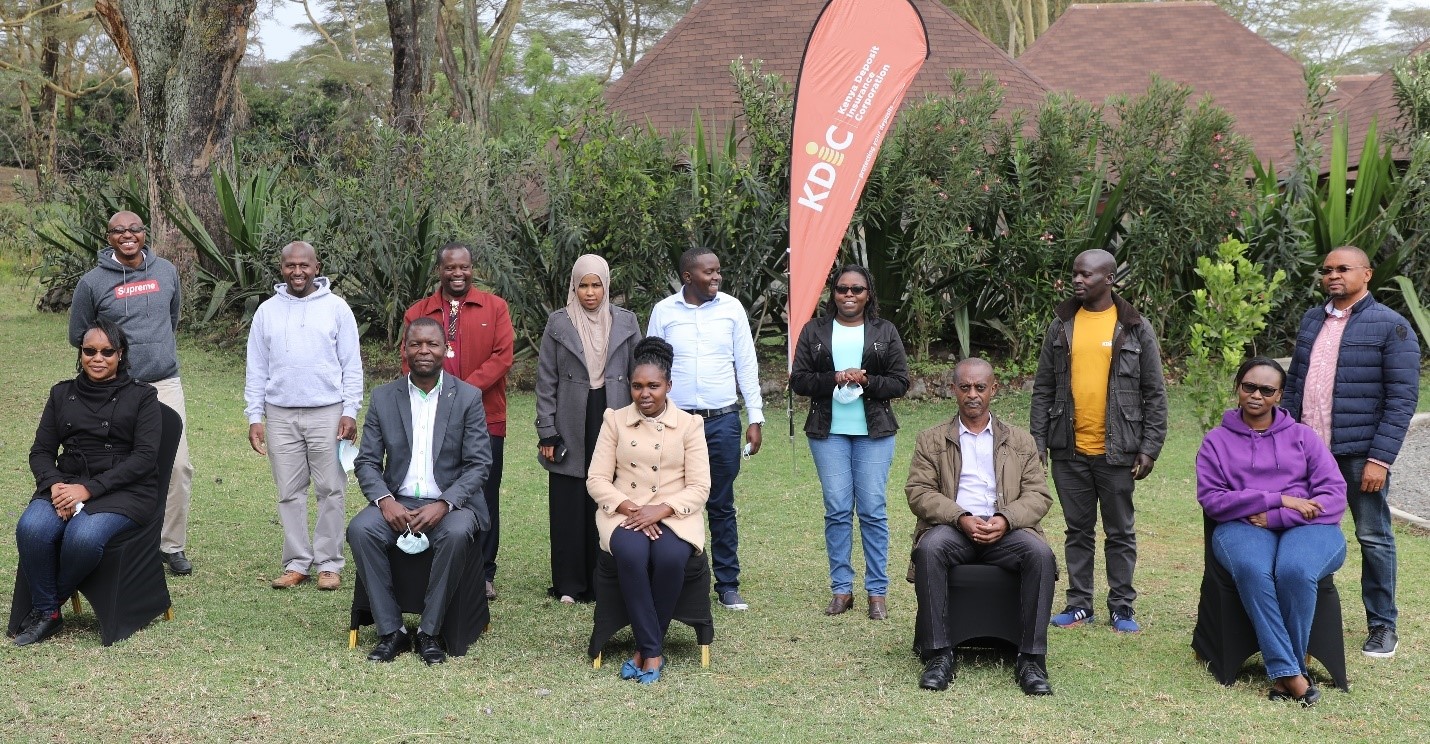  A section of staff alongside the independent consultant pose for a group photo during a previous session on QMS